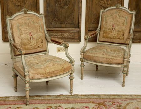 A pair of French painted wood and upholstered fauteuils