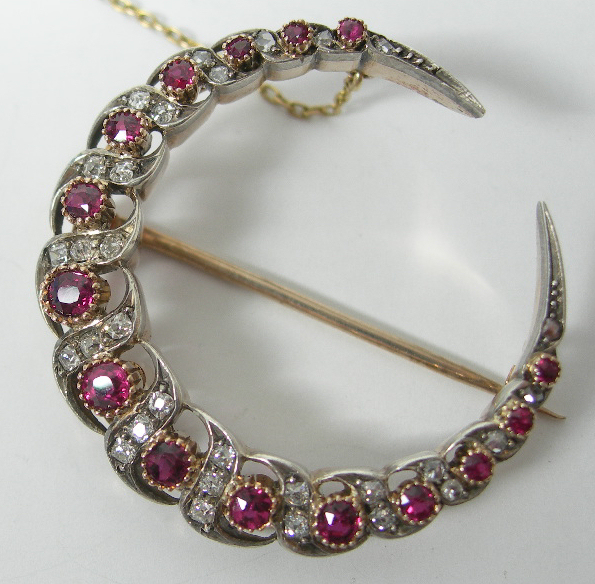 A ruby and diamond crescent brooch,