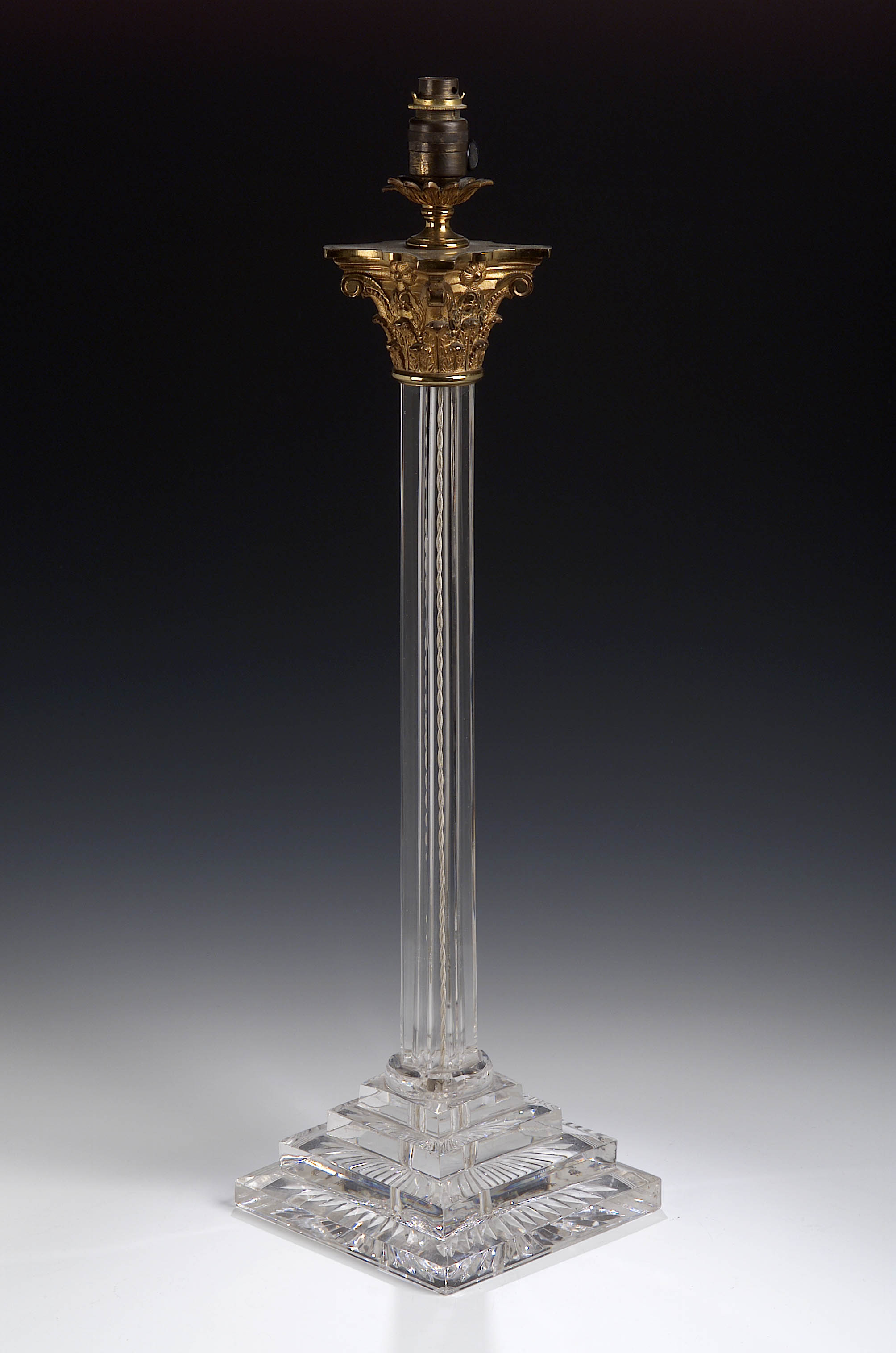 A late 19th century glass and gilt brass Corinthian column table lamp