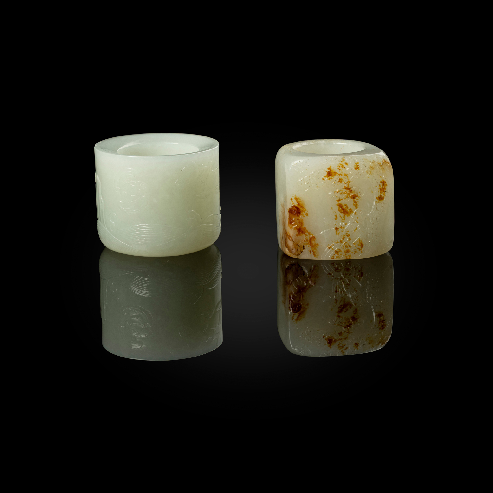 TWO CHINESE WHITE JADE THUMB RINGS