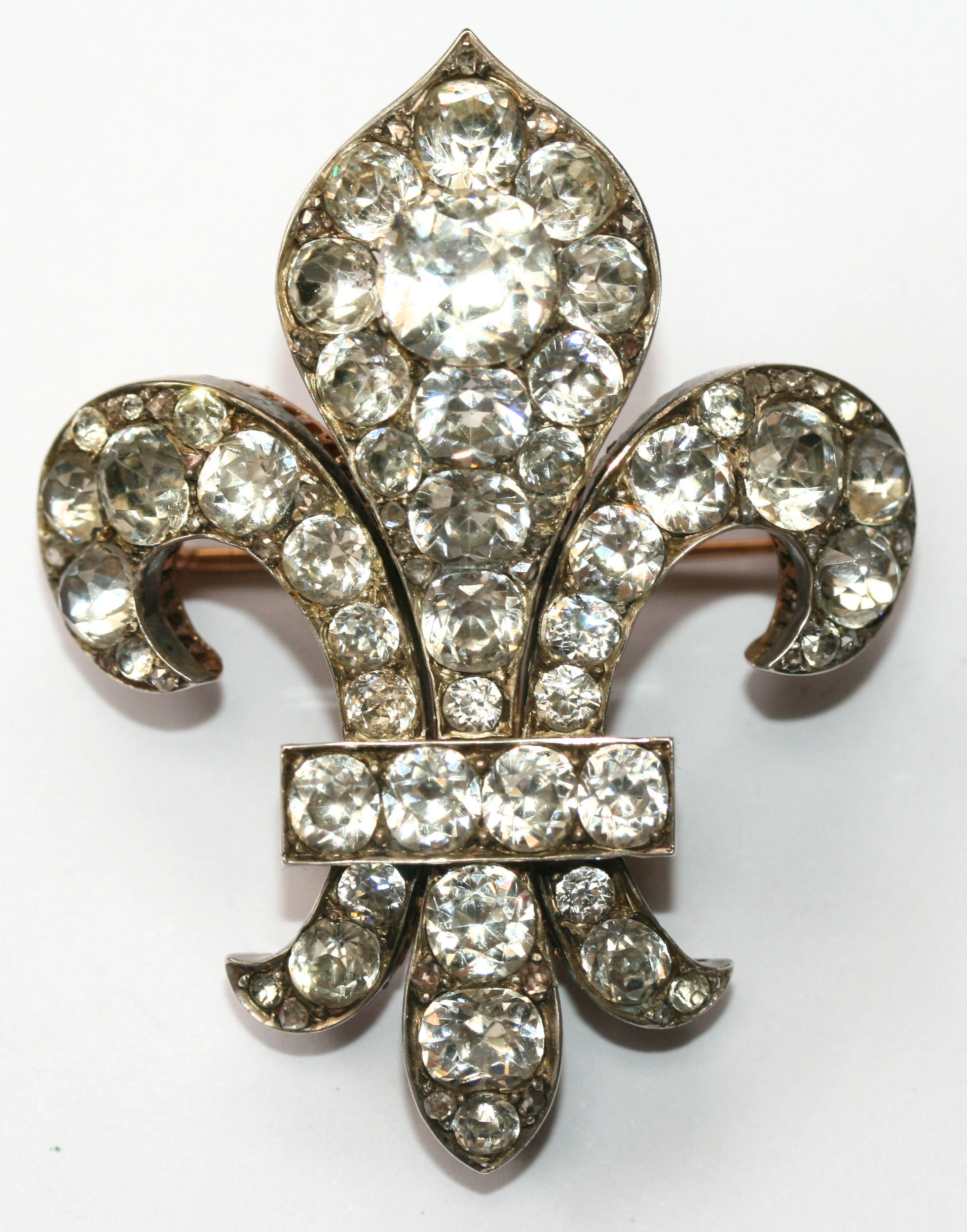 A 19th century paste and diamond set fleur de lys brooch