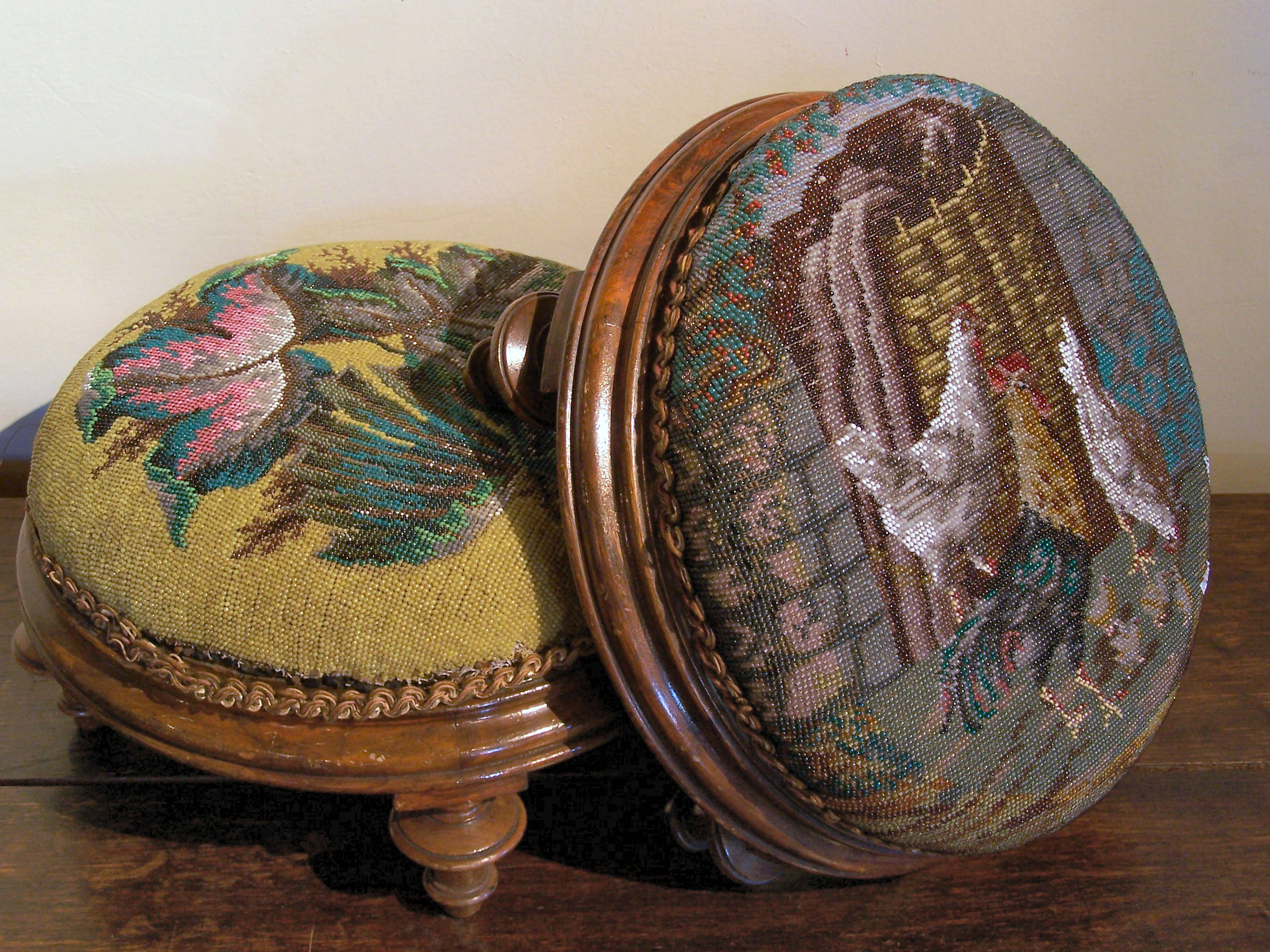 A pair of Victorian walnut circular footstools,