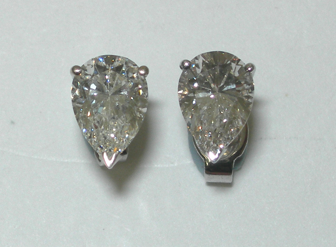 A pair of diamond earrings,