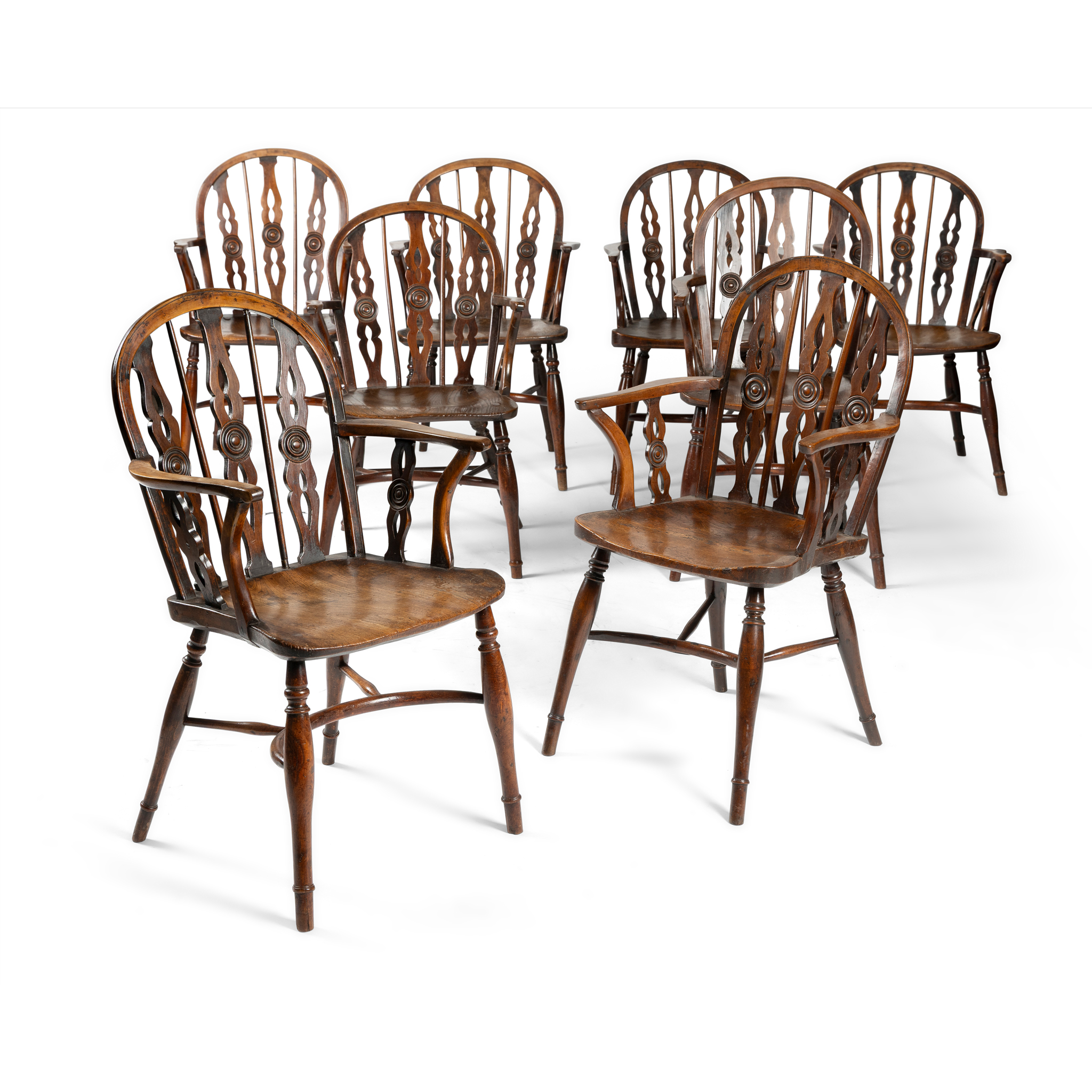 A SET OF EIGHT STAINED ASH AND ELM WINDSOR ARMCHAIRS