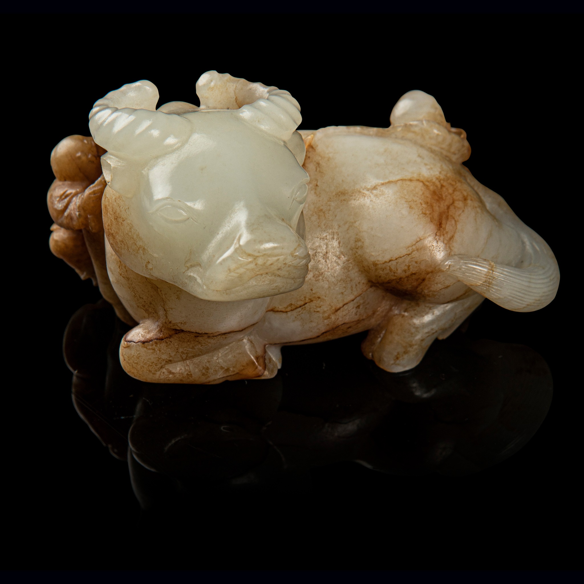 WHITE JADE WITH RUSSET SKIN CARVING OF A BUFFALO WITH BOYS
