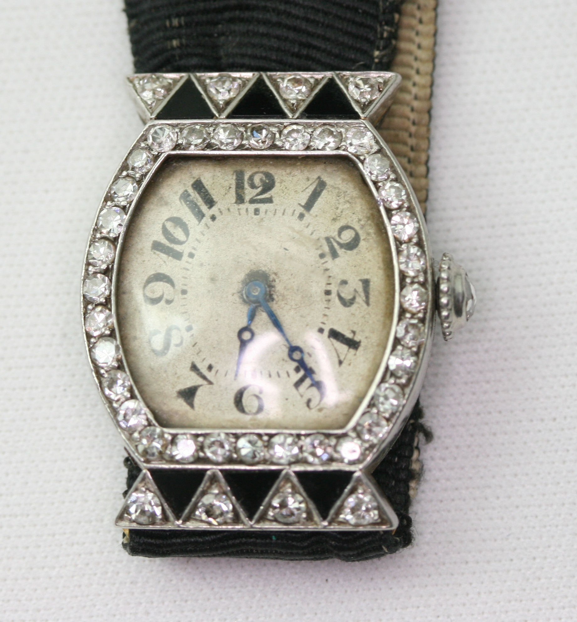 An Art Deco onyx and diamond set cocktail watch