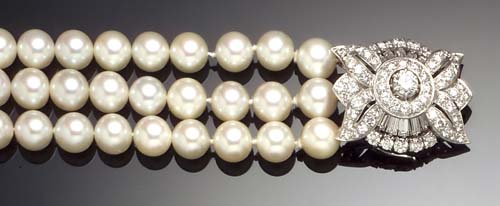 A cultured pearl three-row bracelet with diamond set clasp,