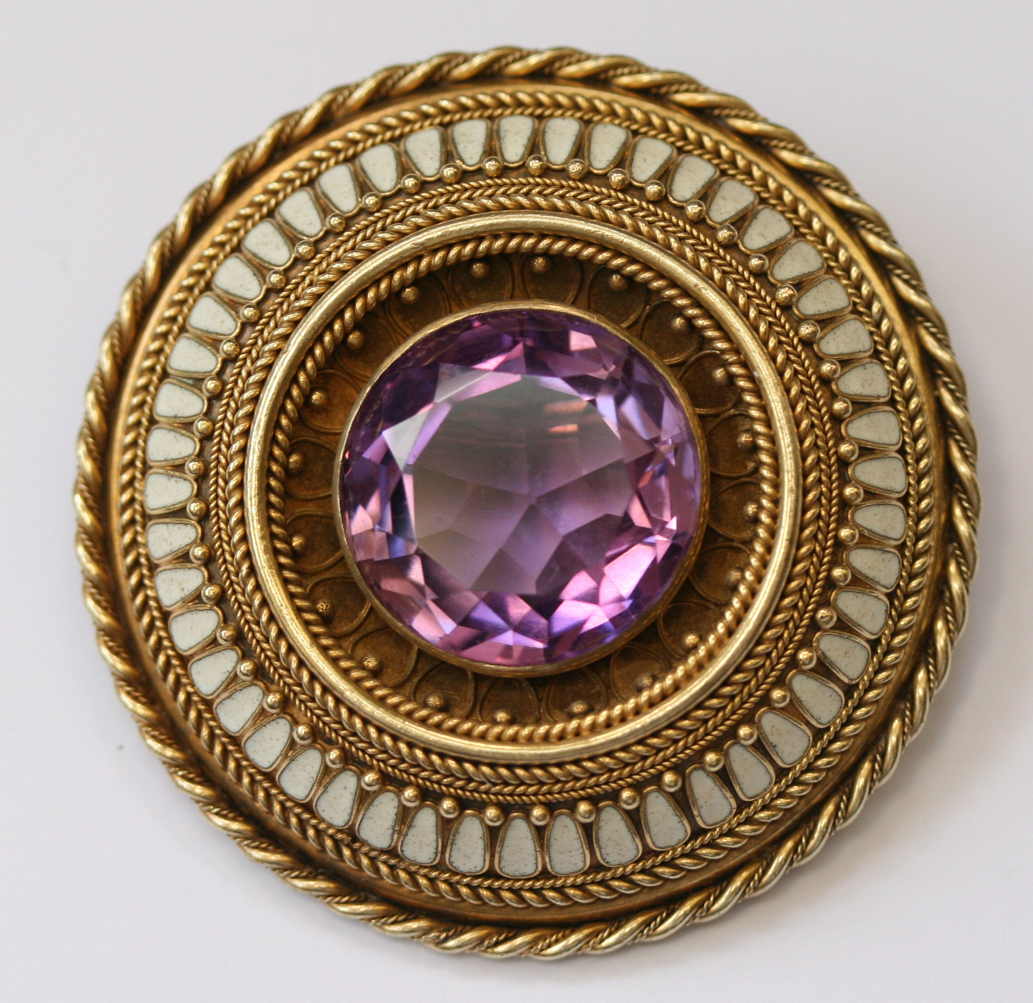 A late 19th century gold, enamel and amethyst brooch