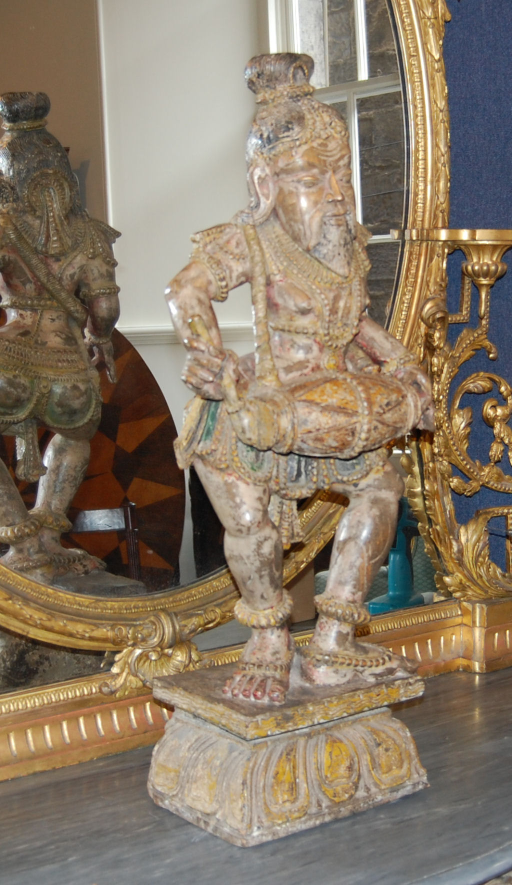 TIBETAN CARVED WOOD AND POLYCHROMED STANDING FIGURE OF A MUSICIAN