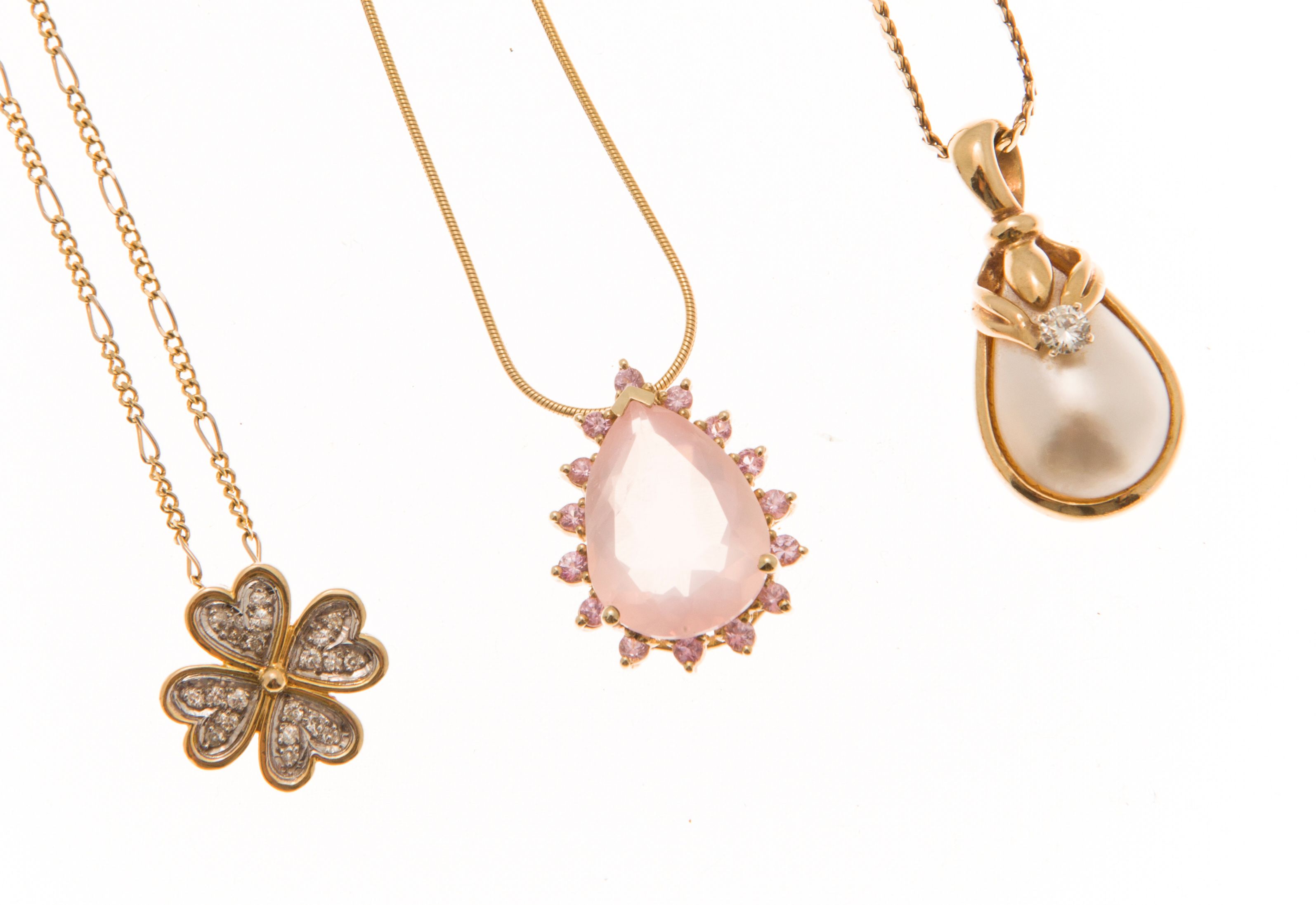A collection of three gem set pendants