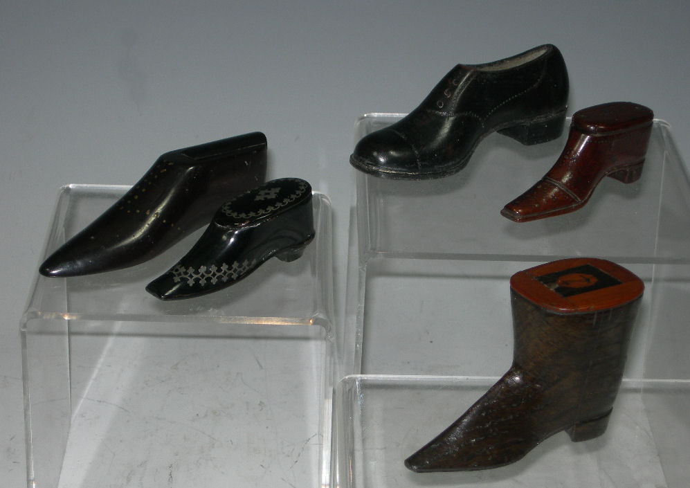 A collection of treen shoe snuff boxes