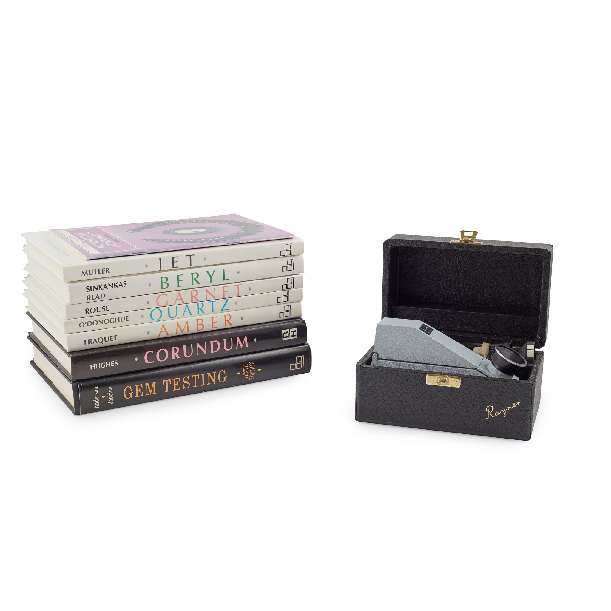 A collection of gemmology reference books and a refractometer