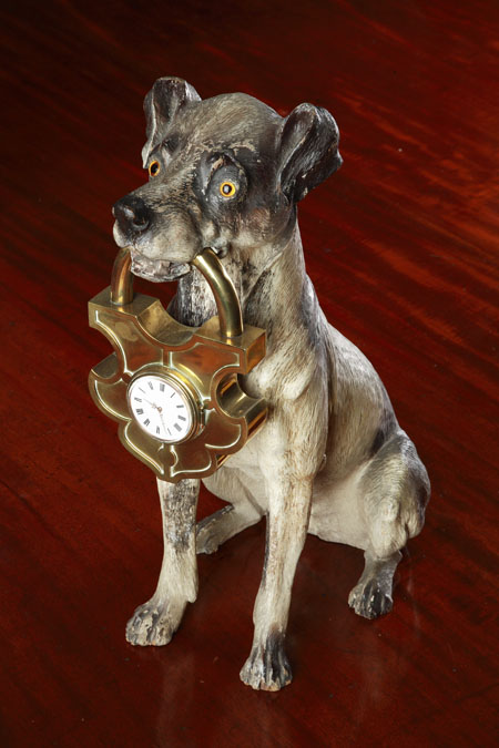 A large Victorian carved and painted softwood model of a seated terrier