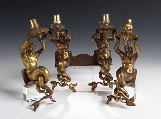 A set of three gilt brass wall brackets