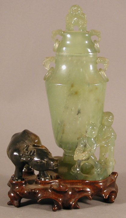 A Chinese jade vase group and cover