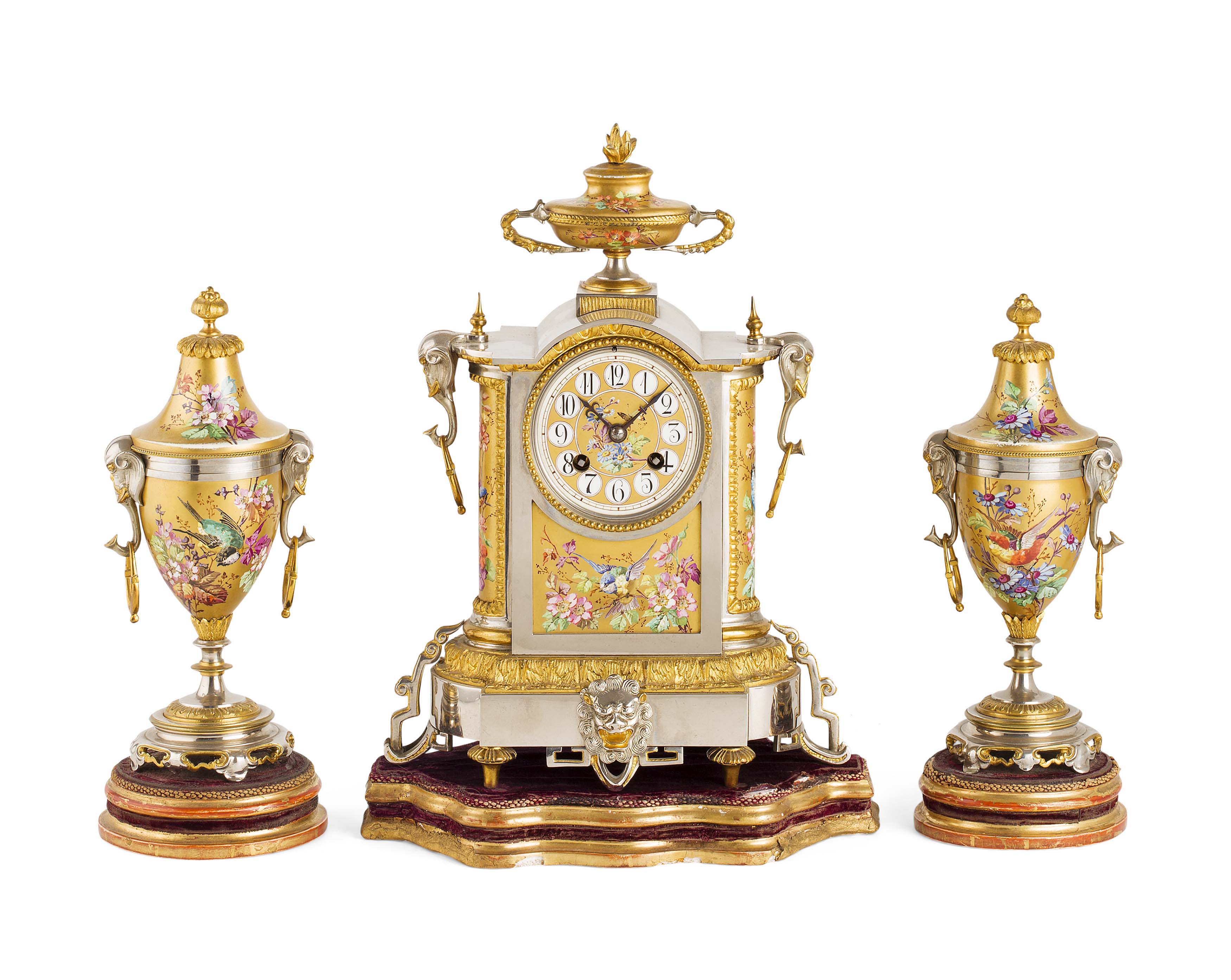 FRENCH GILT AND SILVERED METAL THREE PIECE CLOCK GARNITURE