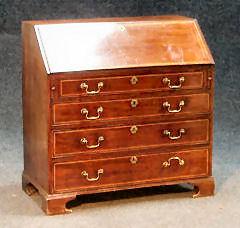 A George III mahogany and boxwood strung bureau