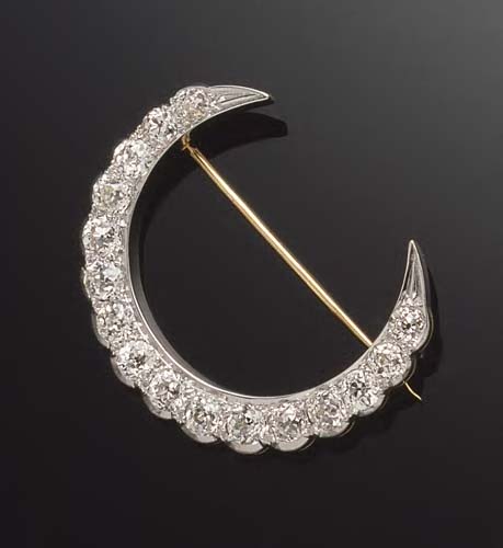 A Victorian style 18ct gold mounted diamond crescent brooch,