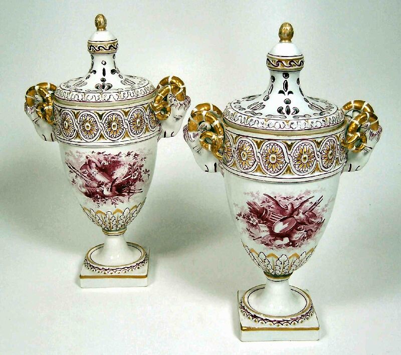 A pair of 19th century French creamware urns and covers