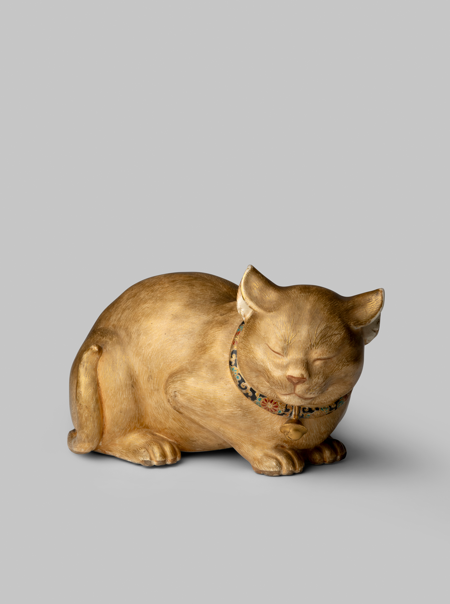 FINE AND RARE JAPANESE SATSUMA OKIMONO OF A LIFE-SIZE CROUCHING CAT