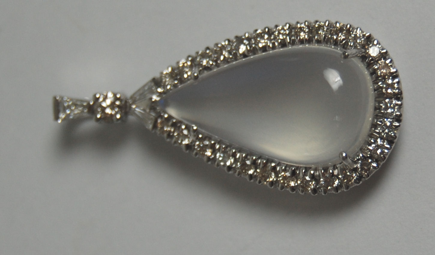 An 18ct white gold mounted moonstone and diamond set pendant