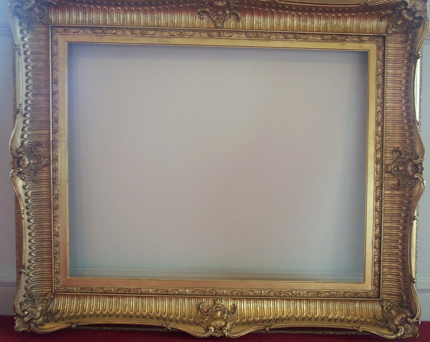 A LARGE AND IMPRESSIVE GILT FRAME
