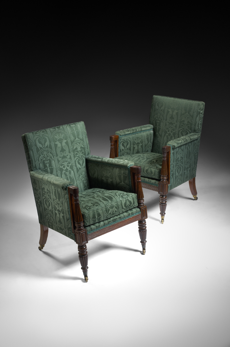A good pair of Regency mahogany and upholstered bergere armchairs