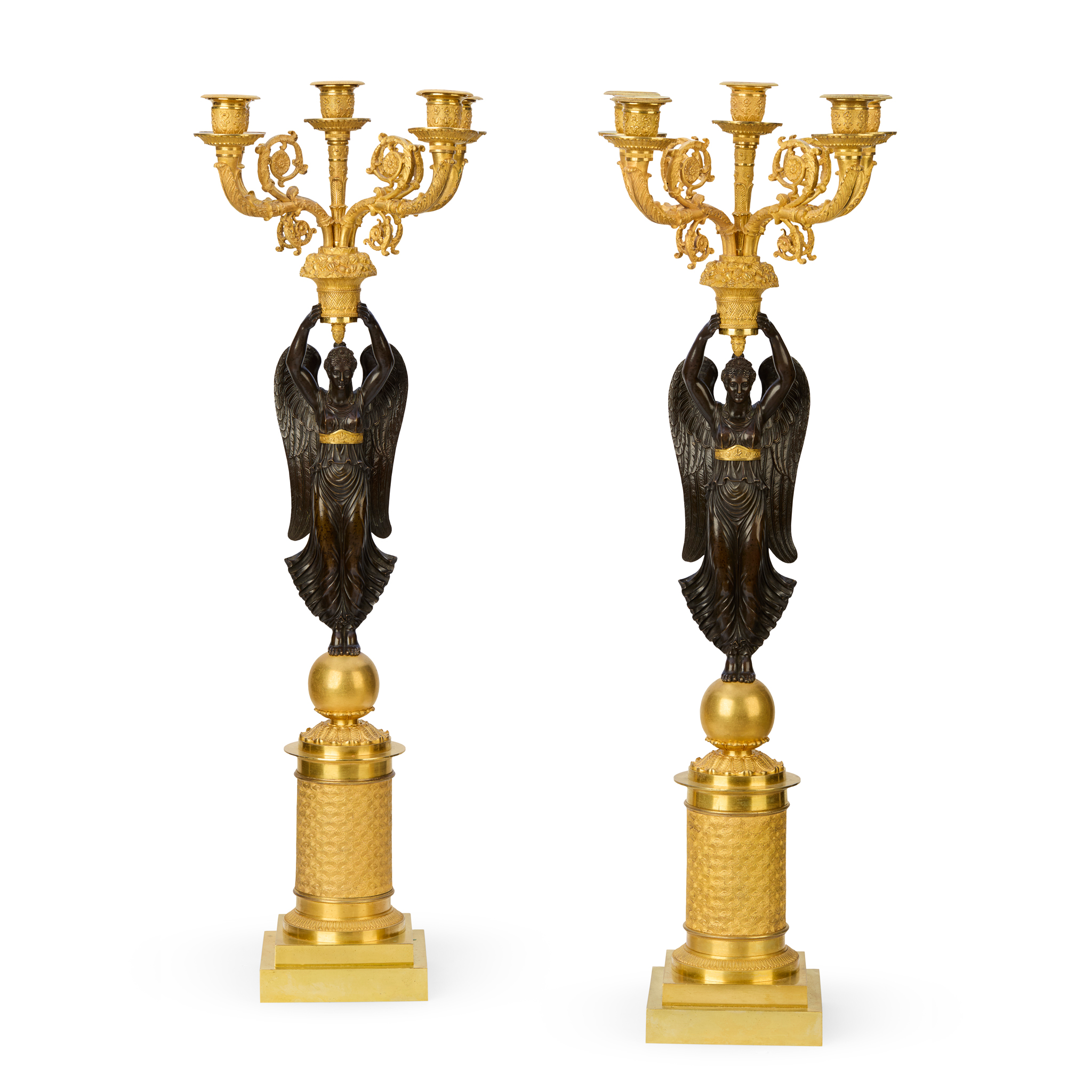 A PAIR OF LARGE GILT AND PATINATED BRONZE FIGURAL FIVE LIGHT CANDELABRA, IN THE MANNER OF PIERRE-PHILIPPE THOMIRE