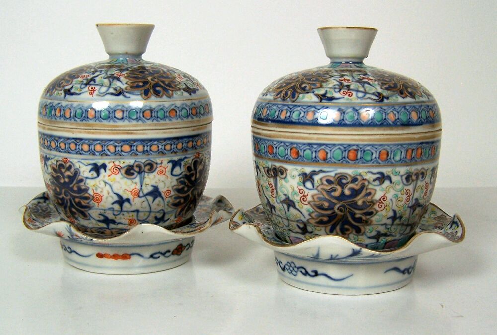 A pair of Chinese rice bowls, covers and stands