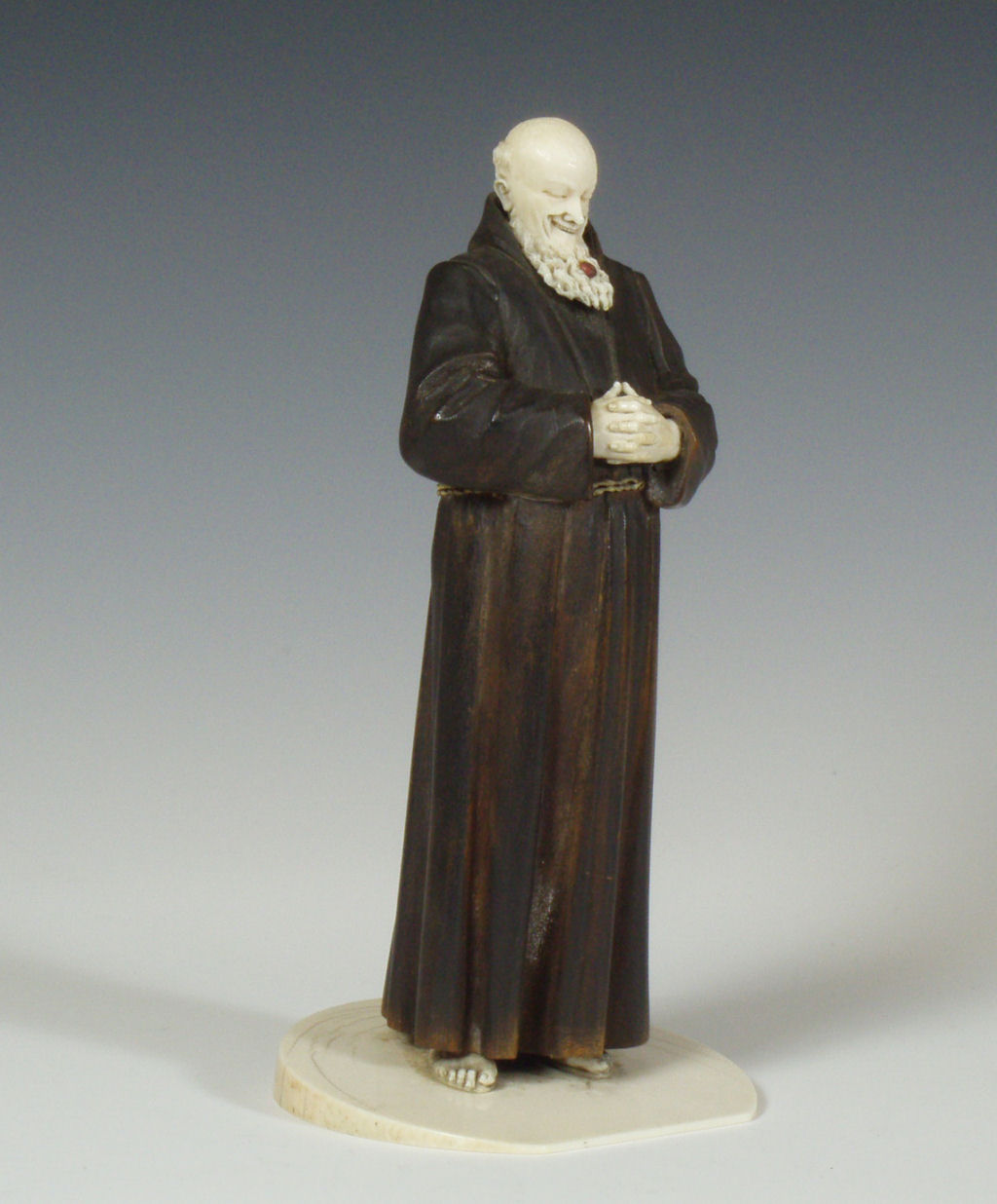 A 19th century German/Austrian carved ivory and wood figure of a monk