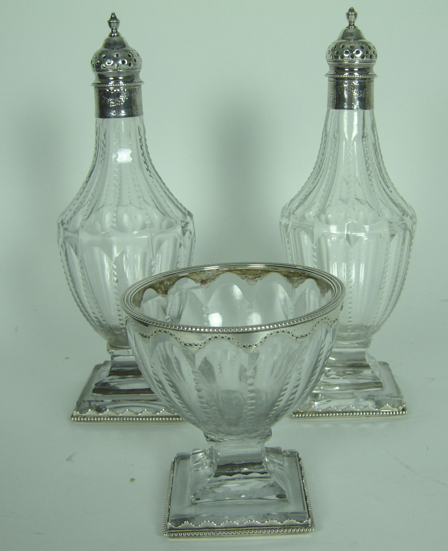 A pair of early 19th century mounted glass castors and matching sugar bowl,