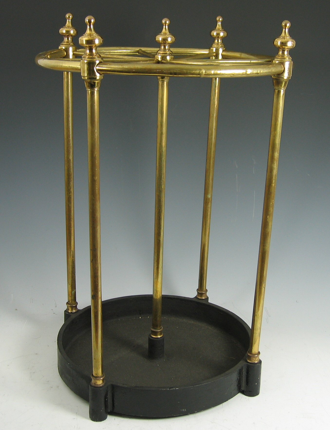 A brass and cast iron stick stand,