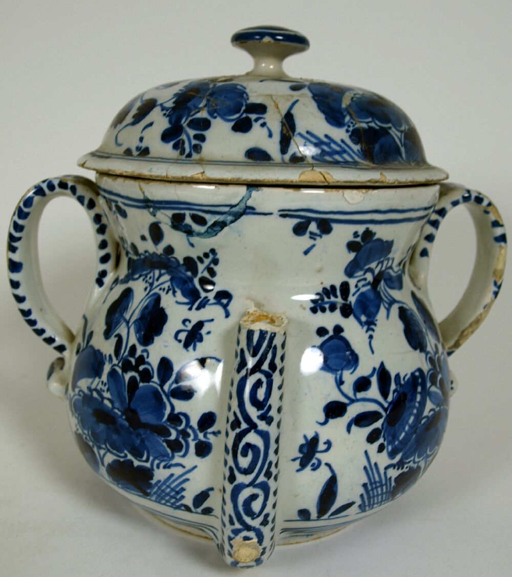 An early 18th century English Delft posset pot and cover London or Bristol