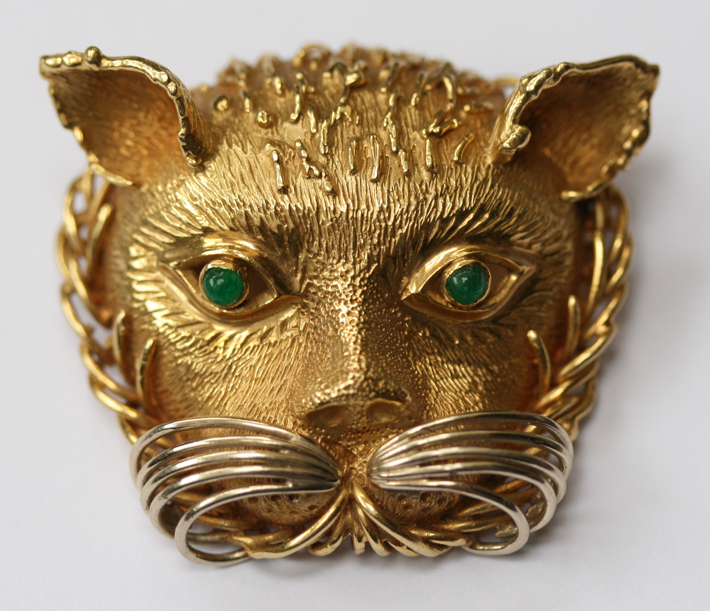 CARTIER - a gem set brooch modelled as a lion's head