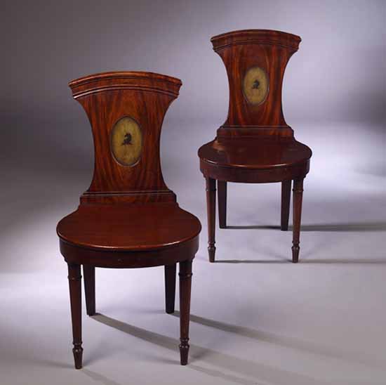 A pair of George III mahogany hall chairs