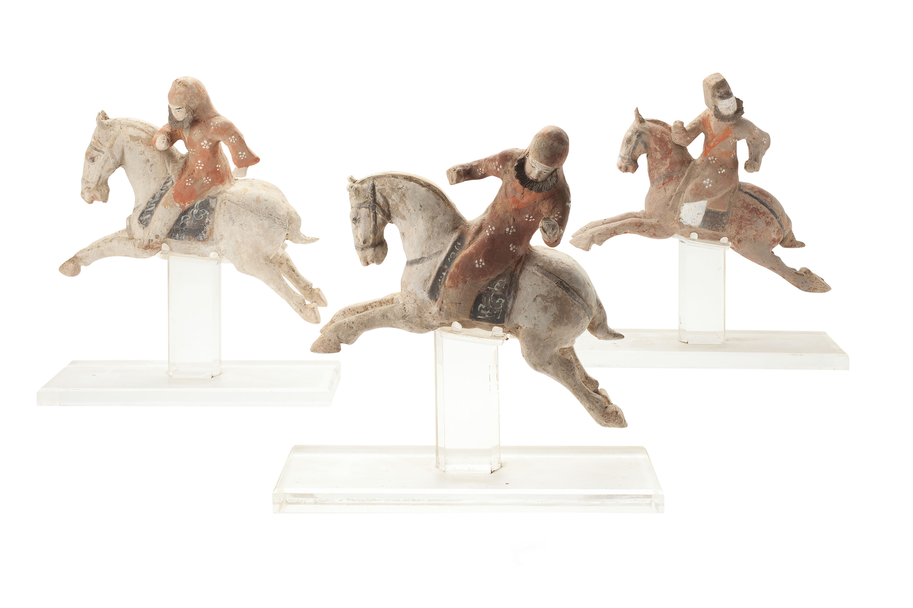 GROUP OF CHINESE THREE POTTERY POLYCHROMED FIGURES OF POLO PLAYERS