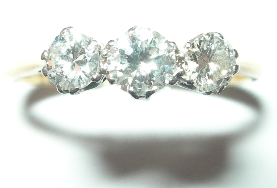 An 18ct gold and platinum mounted three-stone diamond ring,