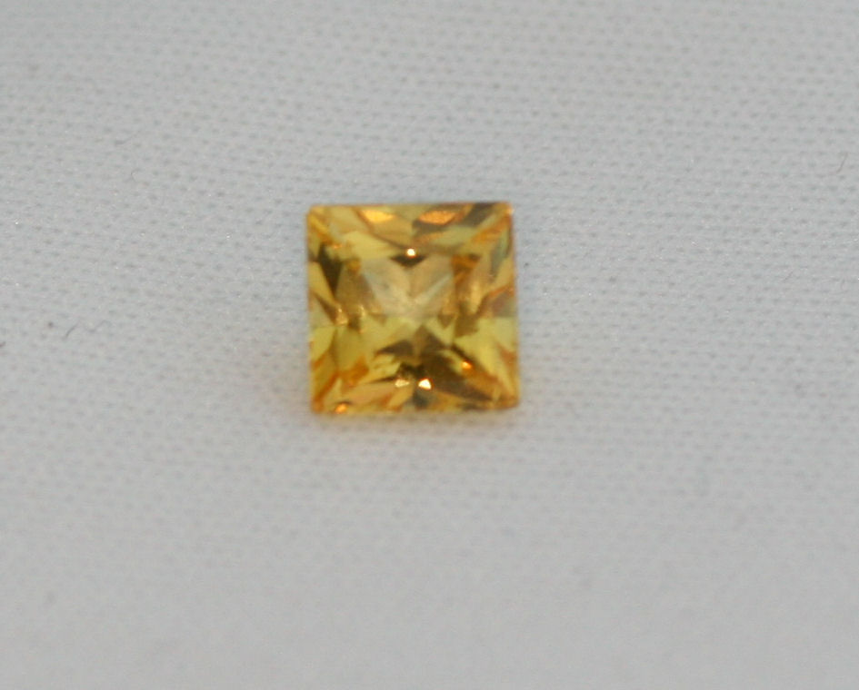 An unmounted square cut yellow sapphire,