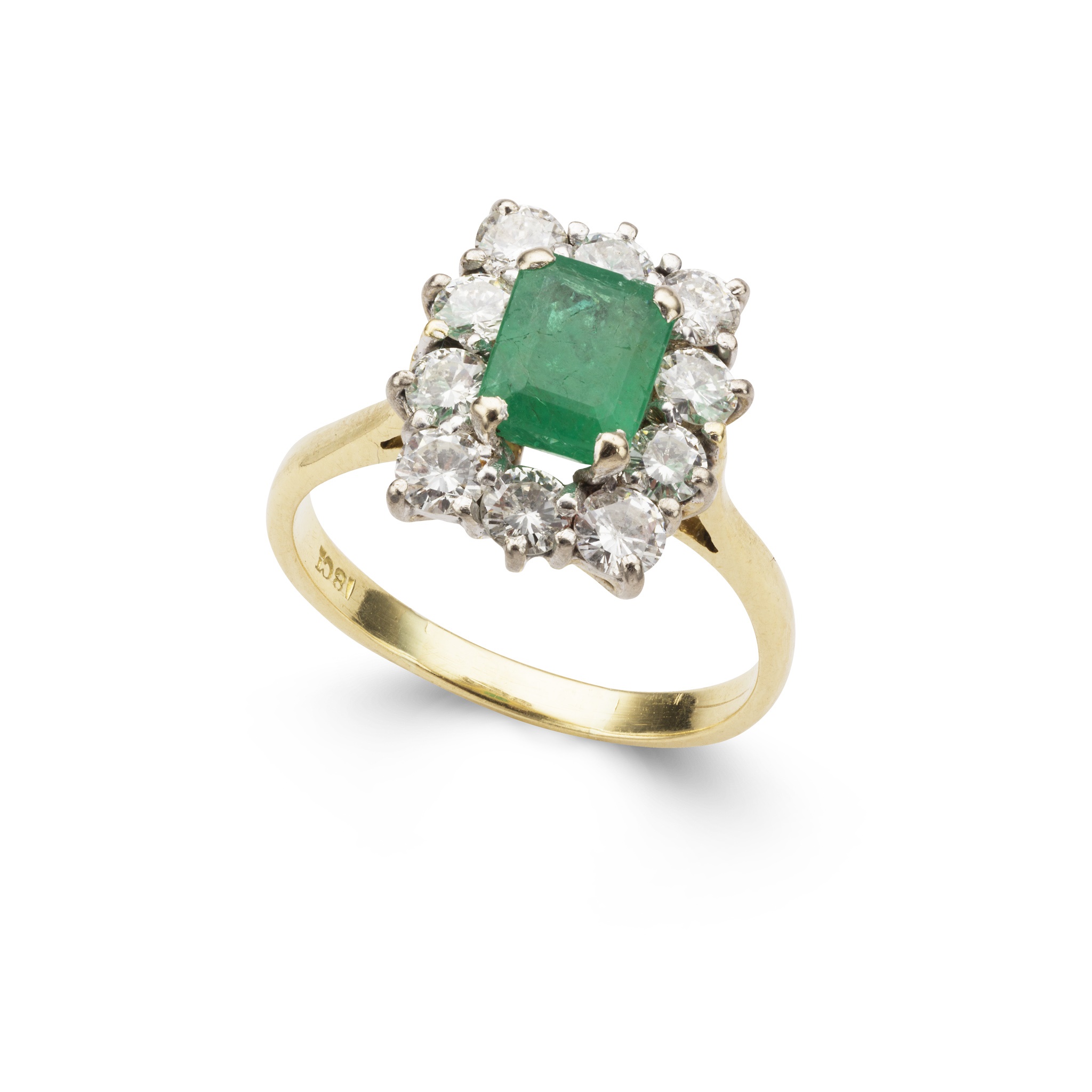 A rectangular- cut emerald and diamond cluster ring