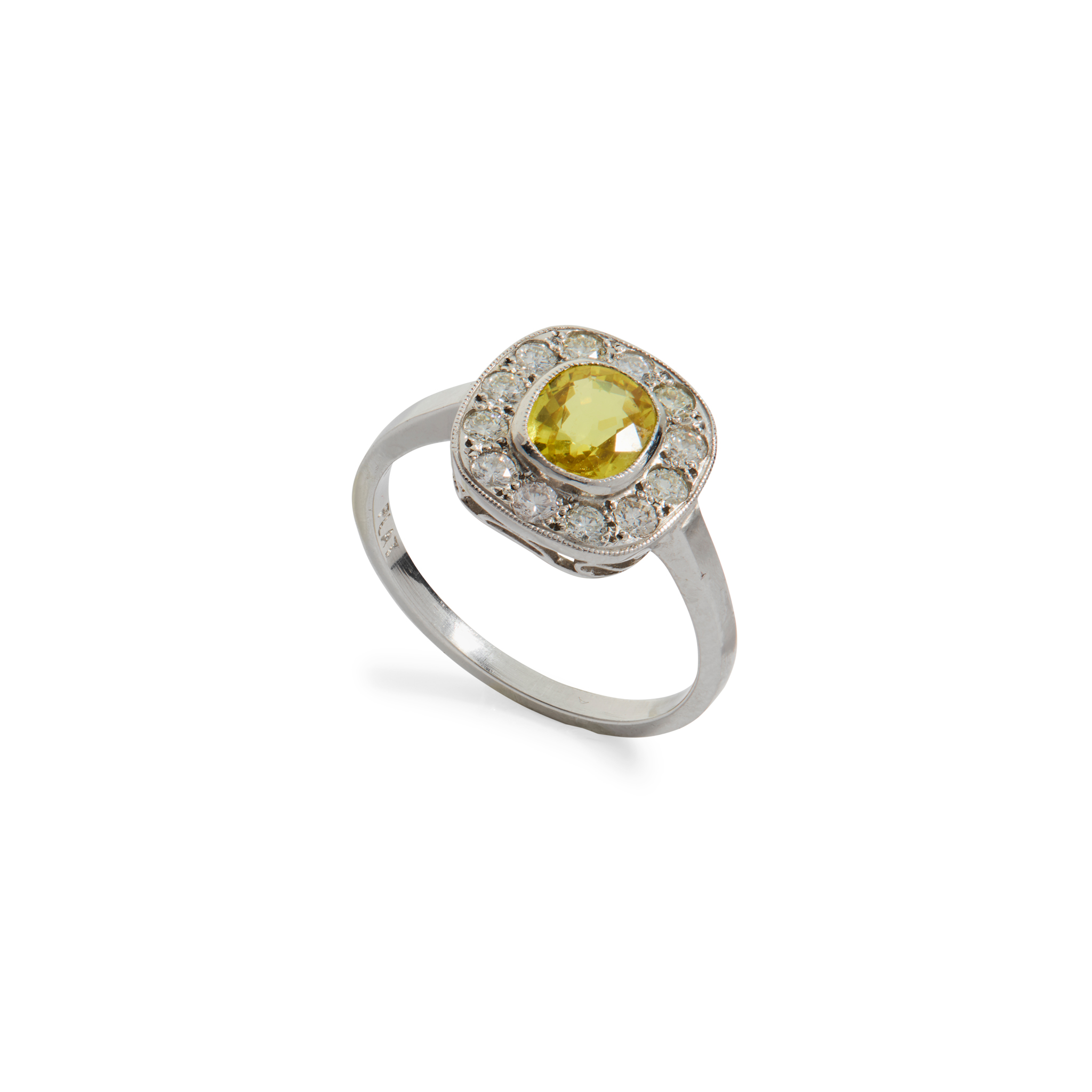 A platinum yellow sapphire and diamond cluster ring