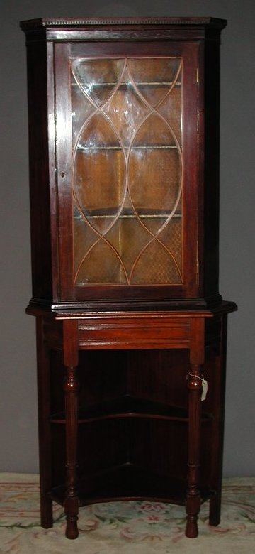 A mahogany and boxwood strung floor standing corner cupboard