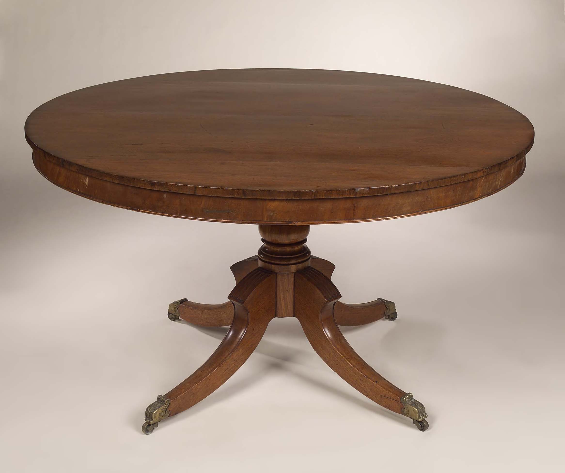An early 19th century circular mahogany breakfast table,
