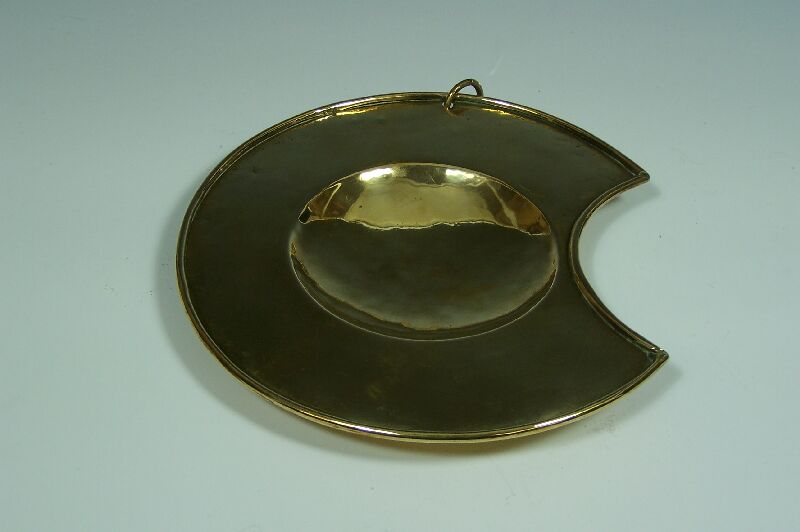 An early 18th century brass bleeding bowl