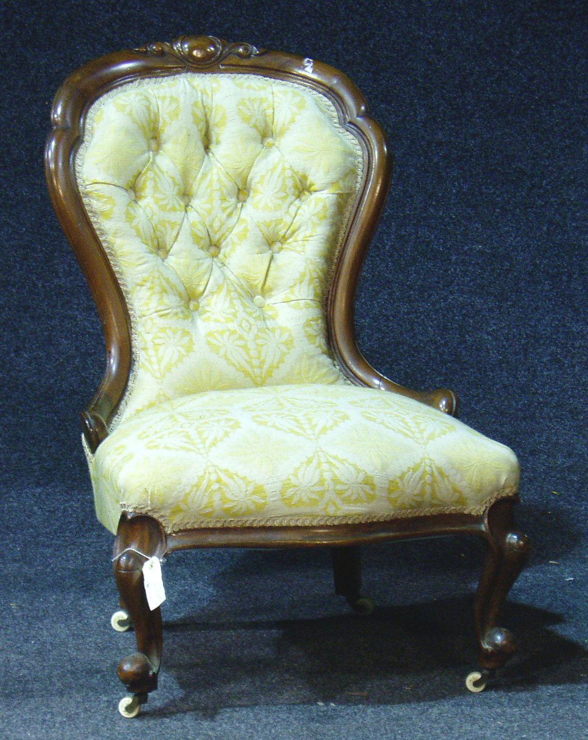 A Victorian spoon back easy chair,