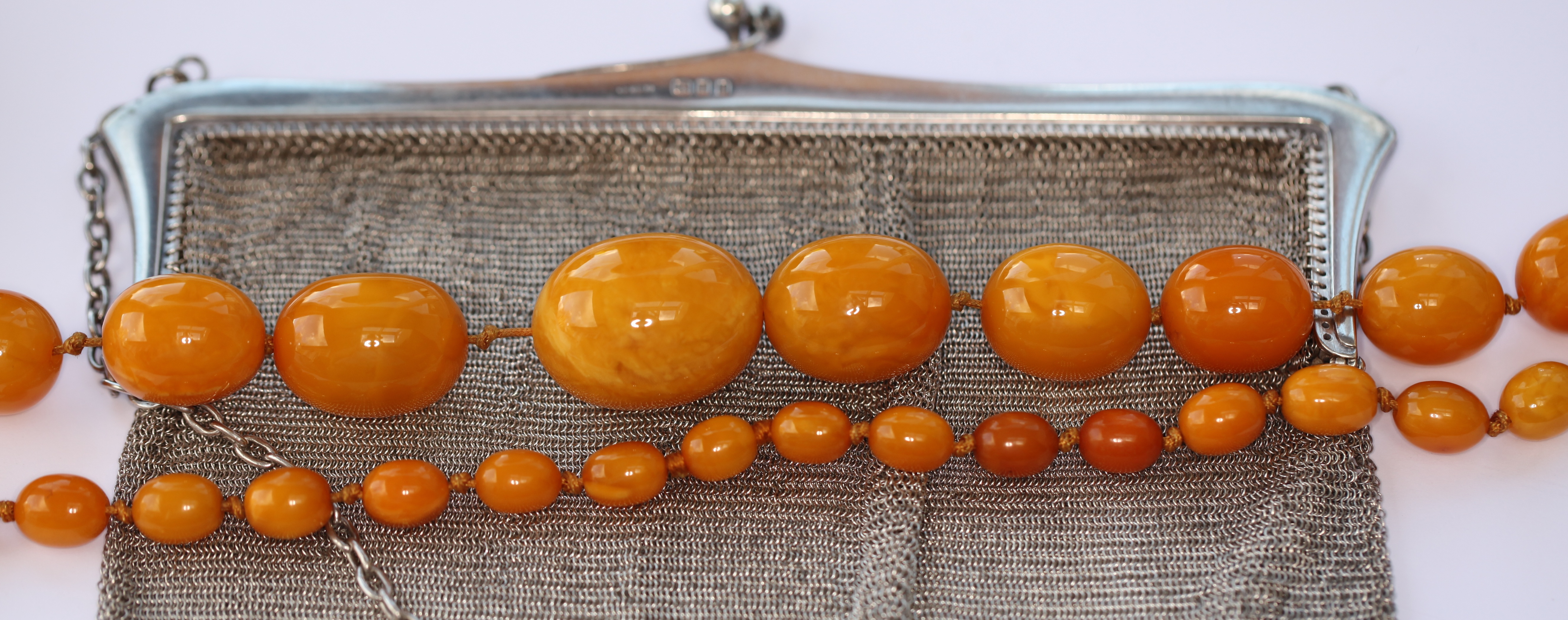 An amber bead necklace and a silver purse