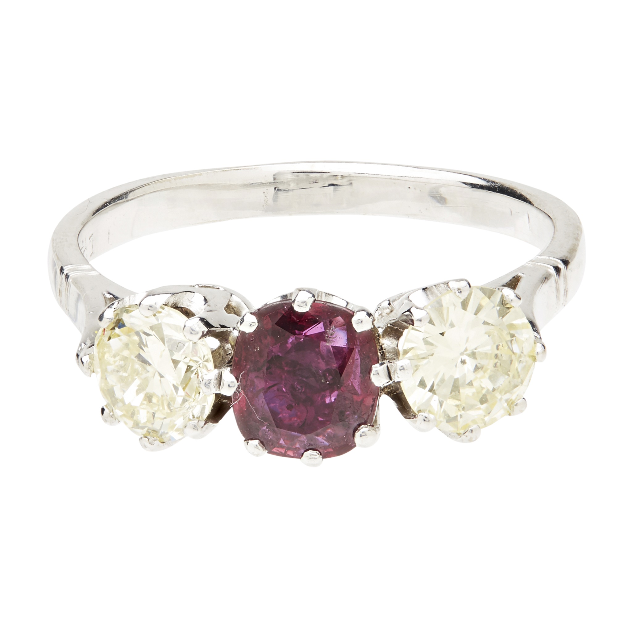 A ruby and diamond set three stone ring