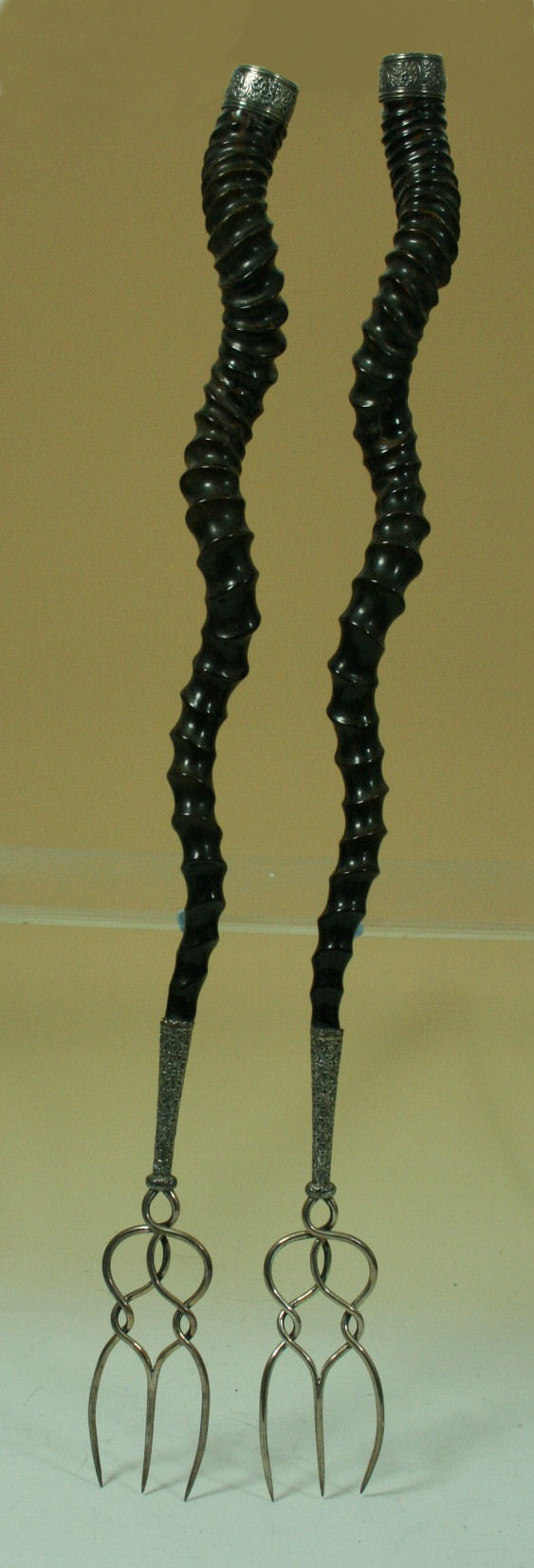 A pair of Victorian silver mounted bannock forks