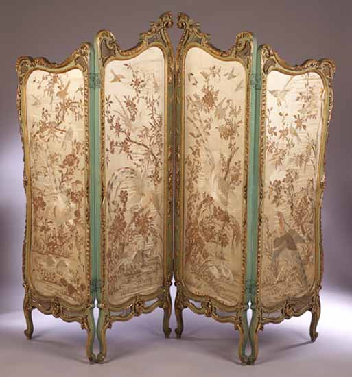 A carved giltwood and painted four fold screen