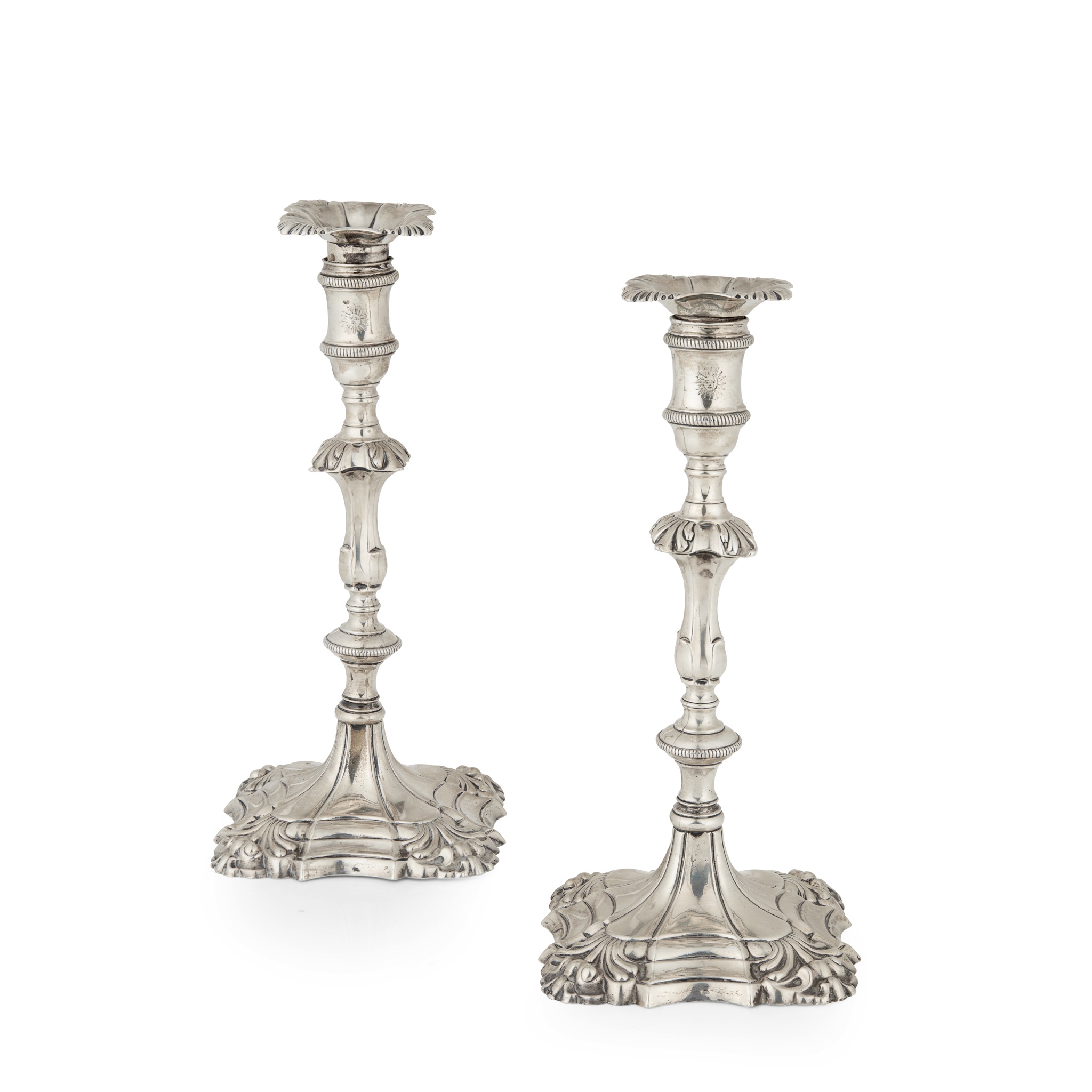 A pair of George III cast table candlesticks
