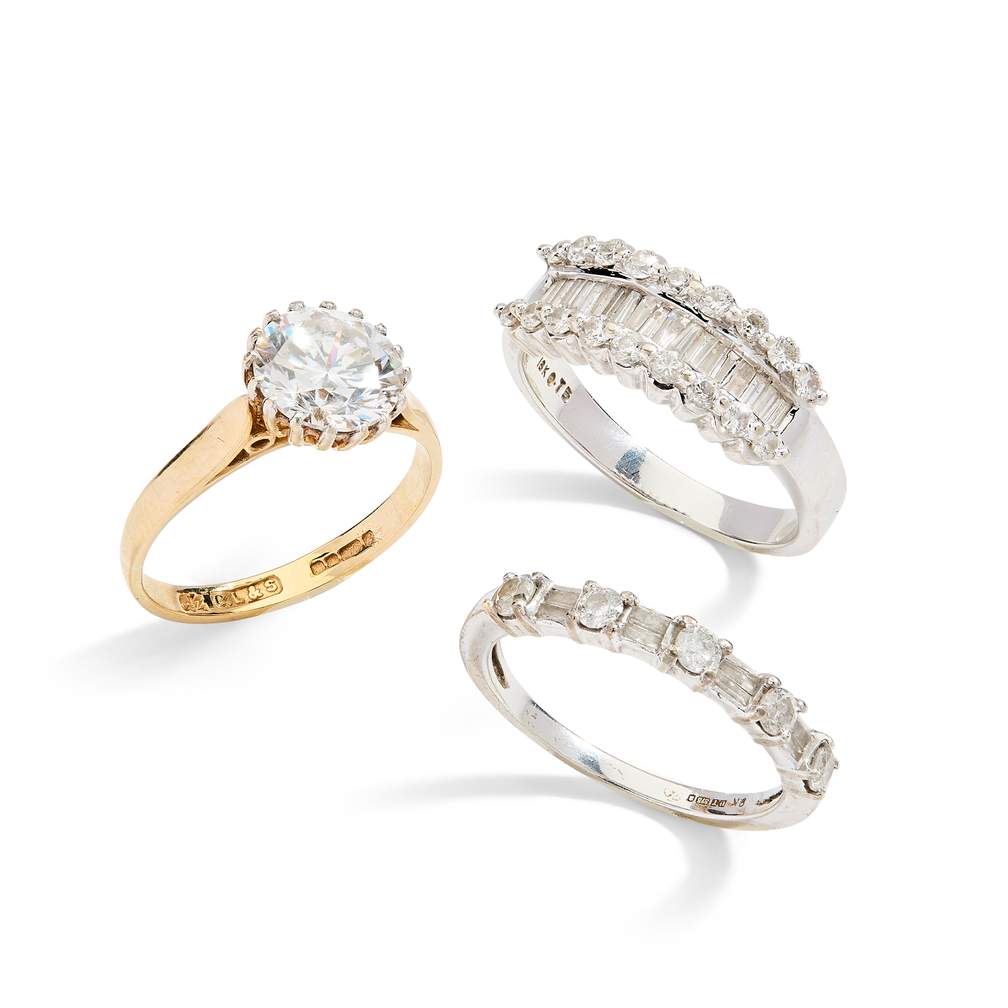 Two diamond half-eternity rings and a single-stone ring